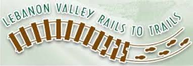 Logo of Lebanon Valley Rails to Trails featuring a stylized train track and footprints.
