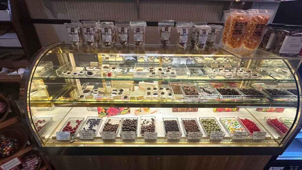 A display case filled with various chocolates and candies.