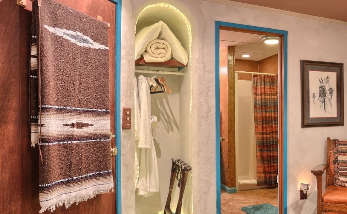 Interior view of a cozy bathroom with towels hanging, a shower curtain, and decorative items.