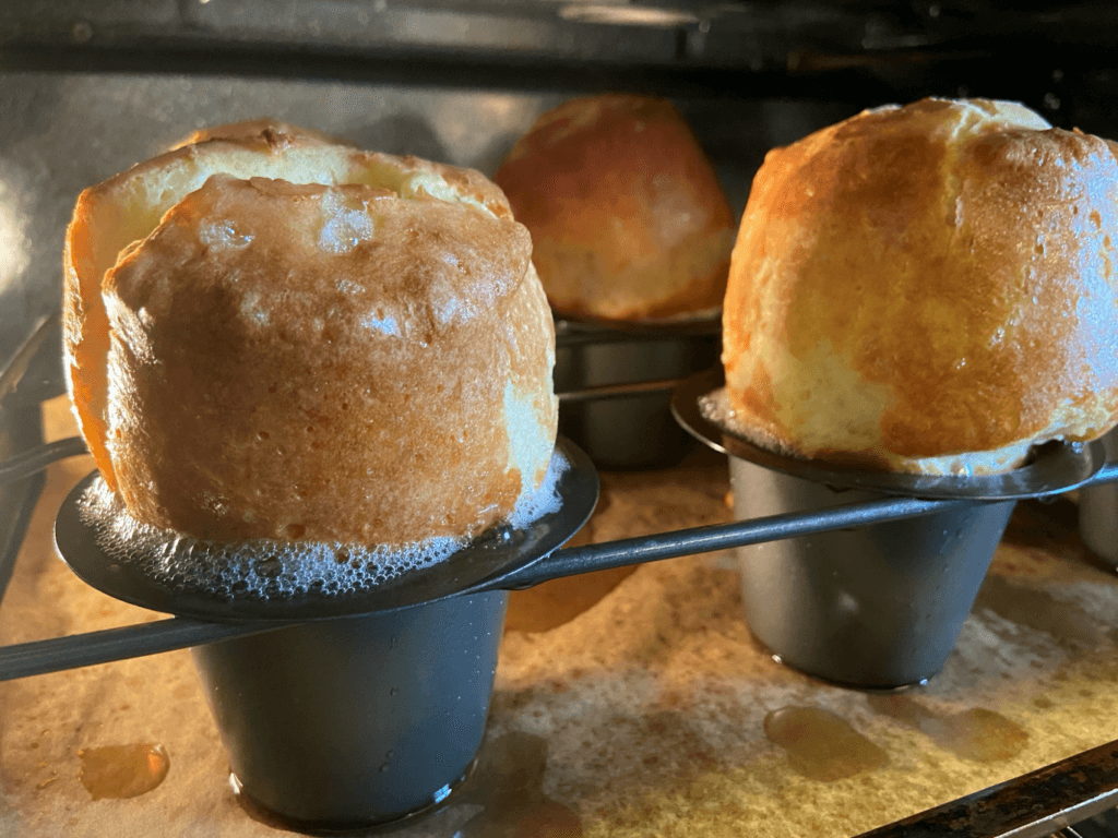 Golden-brown popovers baking in a hot oven.