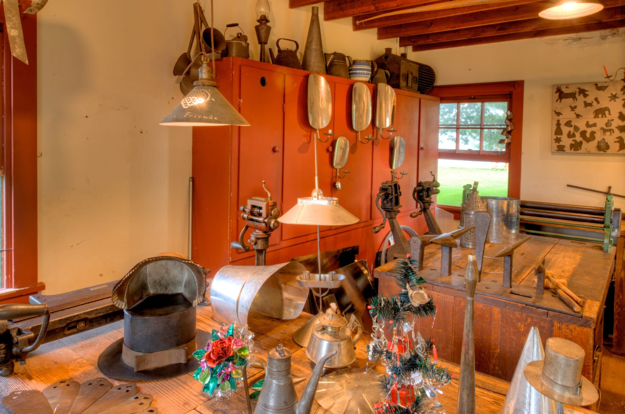 A historic workshop filled with various metalworking tools and lamps.