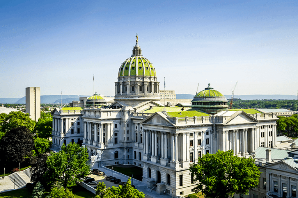 The Pennsylvania State Capitol building with its distinctive green dome and classical architecture.