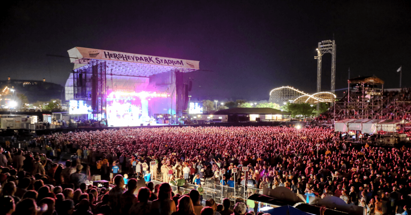 A large crowd gathers at Hersheypark Stadium for a nighttime concert.