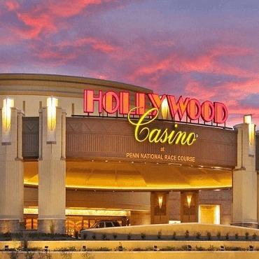 The Hollywood Casino at Penn National Race Course, illuminated against a colorful sunset.
