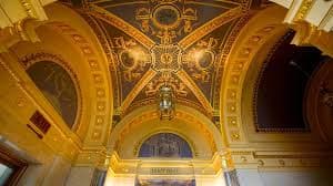 Ornately decorated ceiling with gold accents and intricate designs.
