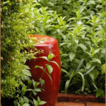Garden Drum--a large red colored pottery piece in the mint corner of the Garden of the Hidden Orange Rose