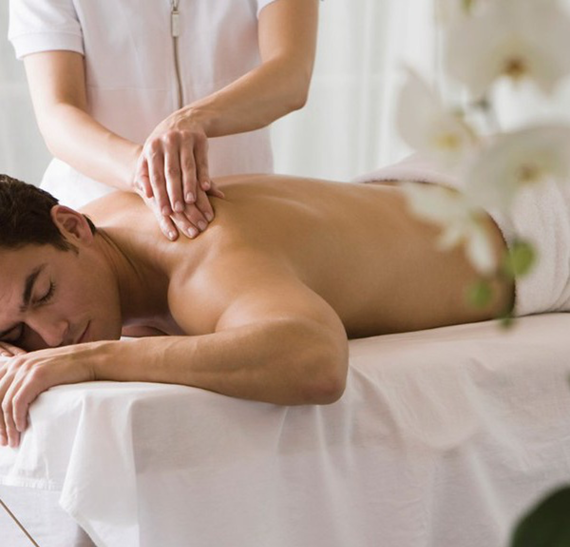 Young Man receiving massage in spa.