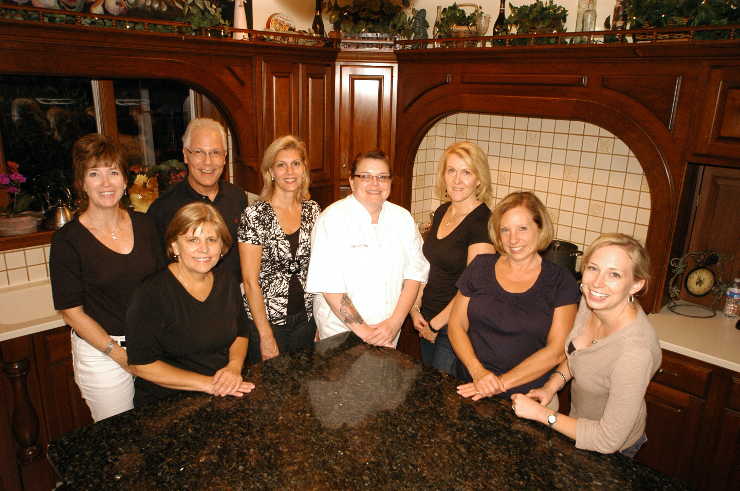 Chef in Ananville Inn kitchen surrounded by seven students for one of Annville Inn's Acclaimed Chef Cooking Classes