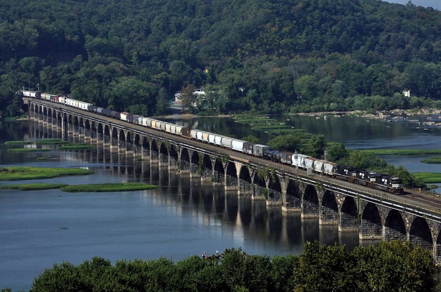 A long, modern freiight train crosses the famed "Rockvale Bridge" just west of Harrisburg, PA