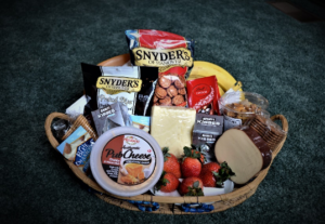 Basket of crackers, cheeses and fruits