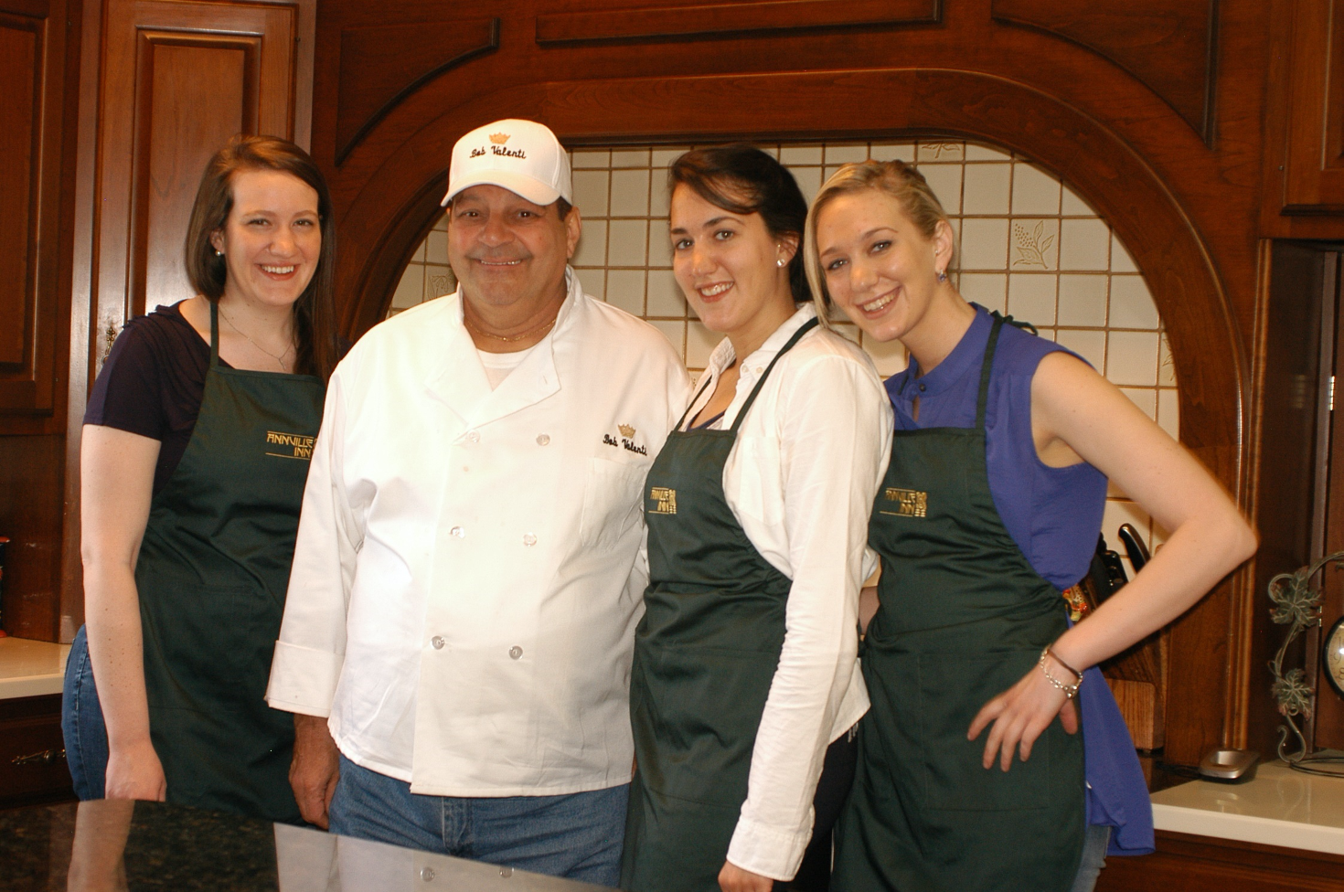 Chef posing with three students in Annville In kitchen