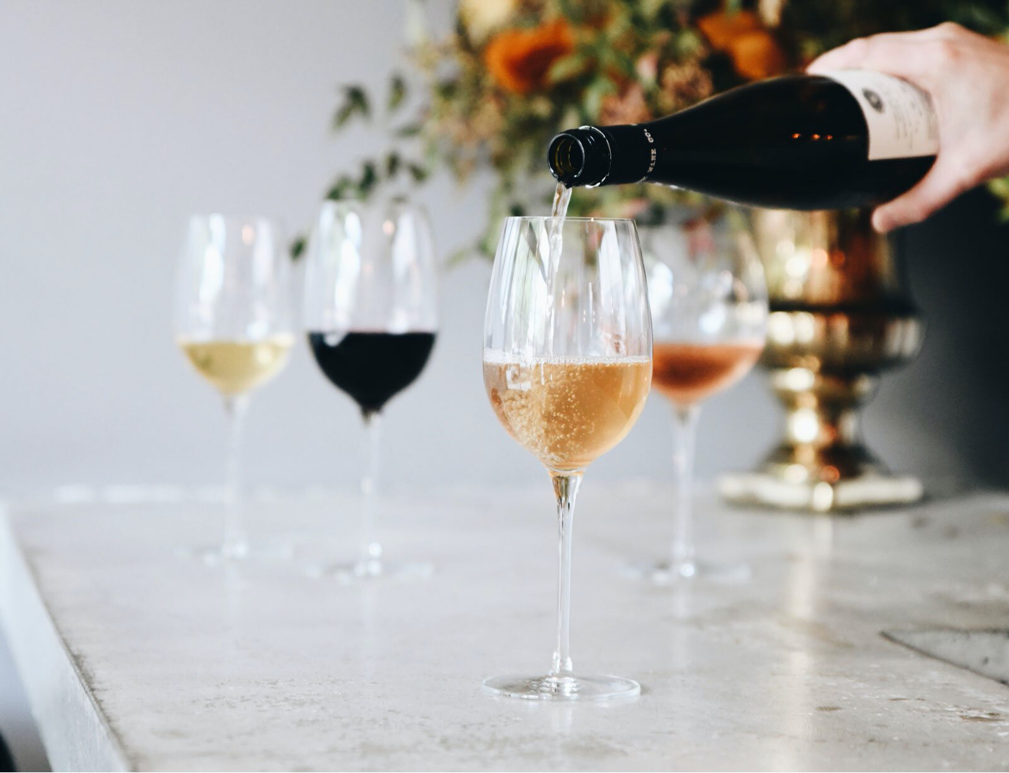 Pouring wines into four goblets