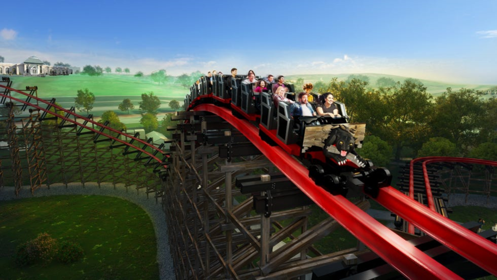 Photo of Wildcat Revenge Roller Coaster at HersheyPark and near Annville Inn B&B.  Shows a train of roller coaster ars with people in them gliding down bright red metal tracks.