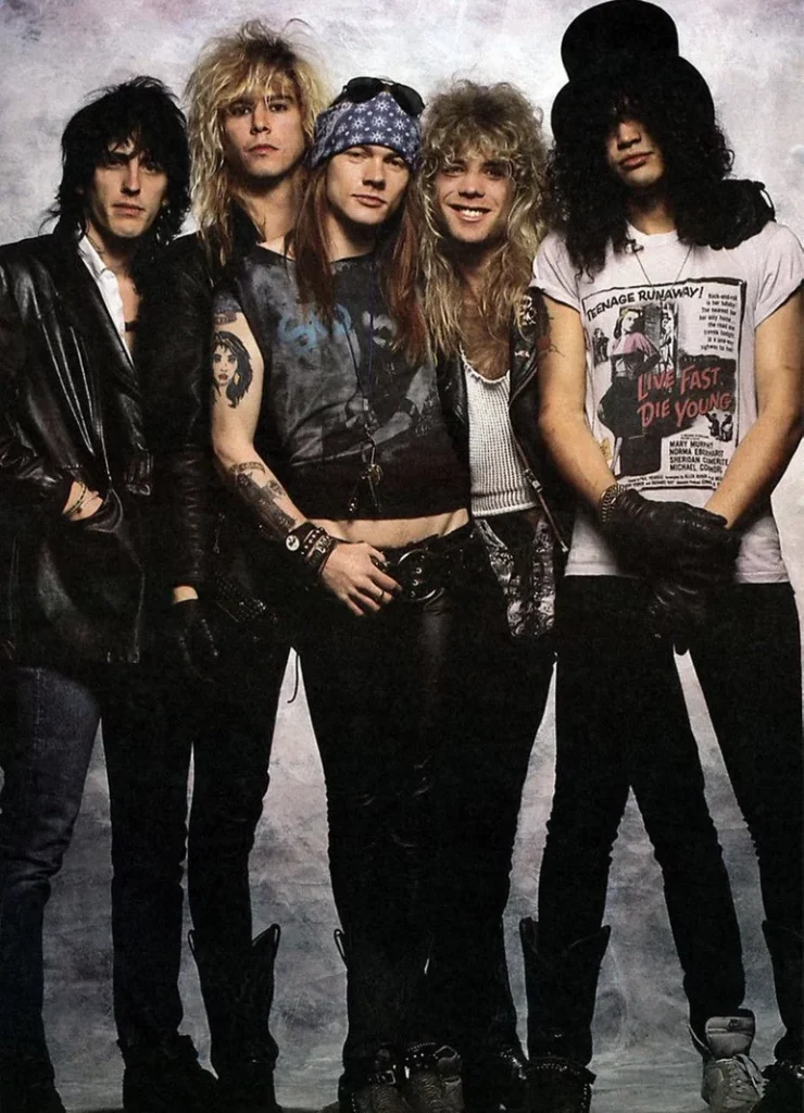 The Band Guns N' Roses is featured in a portrait of all five guys with Brett Michaels in the center. Before GNR, Chicago at Hershey Theatre in April.