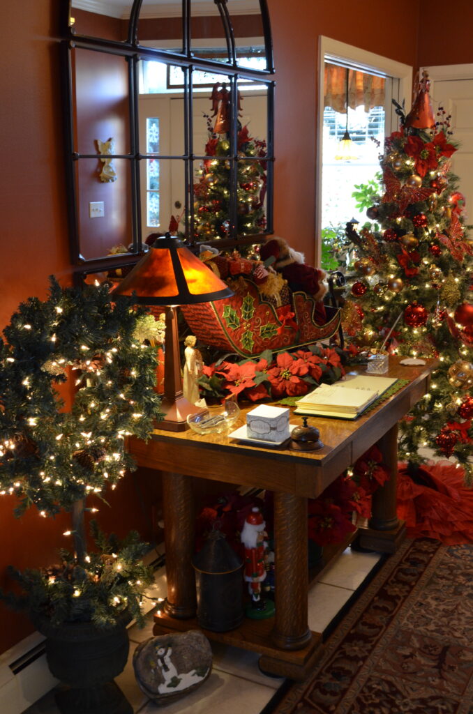 Cozy room decorated for Christmas.  Santa Claus in a sleigh, Poinsettias, and Christmas wreaths. Your Christmas bed and Breakfast Hershey.