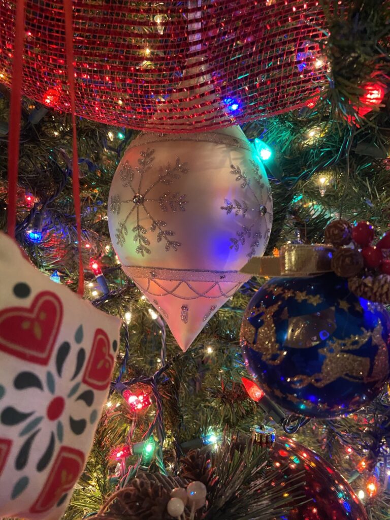 Close up photo of a Christmas Ornament on a Christmas Tree. Christmas Tree with light.