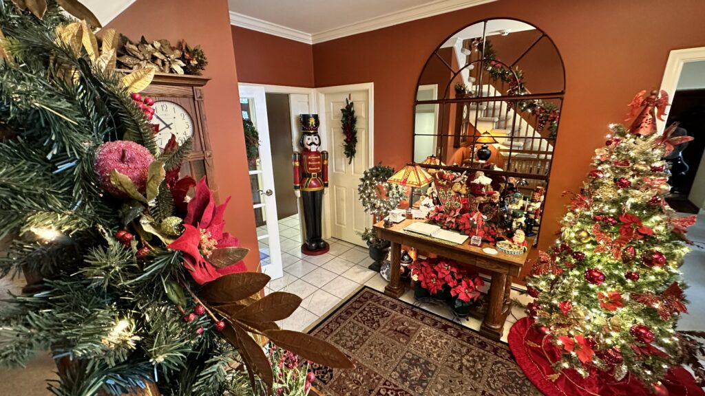 Front Lobby decorated for Christmas. Christmas Tree, full size nutcracker and Poinsettias.