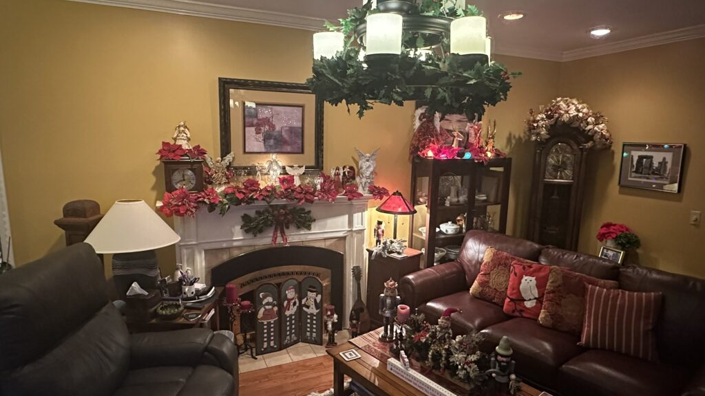 Cozy living room with Christmas decorations. With a decorated chandelier and fire place. Your Christmas Bed and Breakfast Hershey