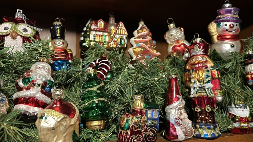 Decorated Bookshelf with Christmas decor. Santa, nutcracker and snowman Christmas ornaments.