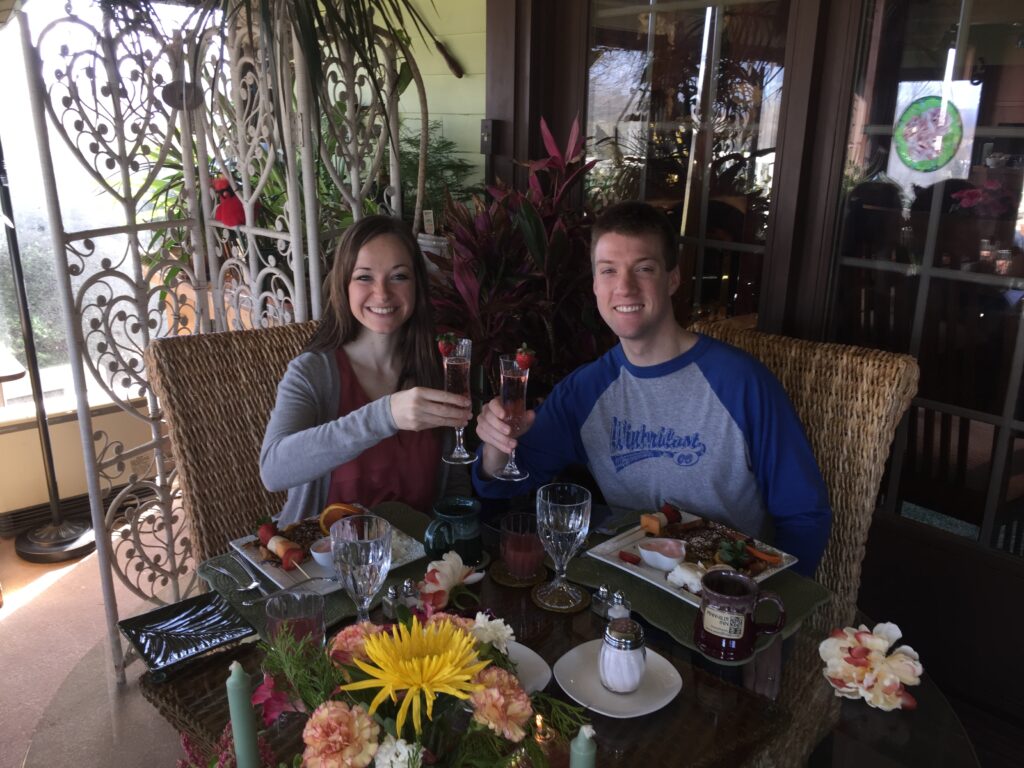 Image of a smiling couple eating breakfast