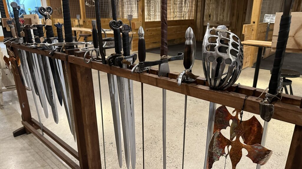 Photo of a rack of swords forged at the Drunken Smithy