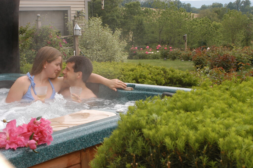 Photo of a couple in a hot top drinking wine. Valentines in Hershey