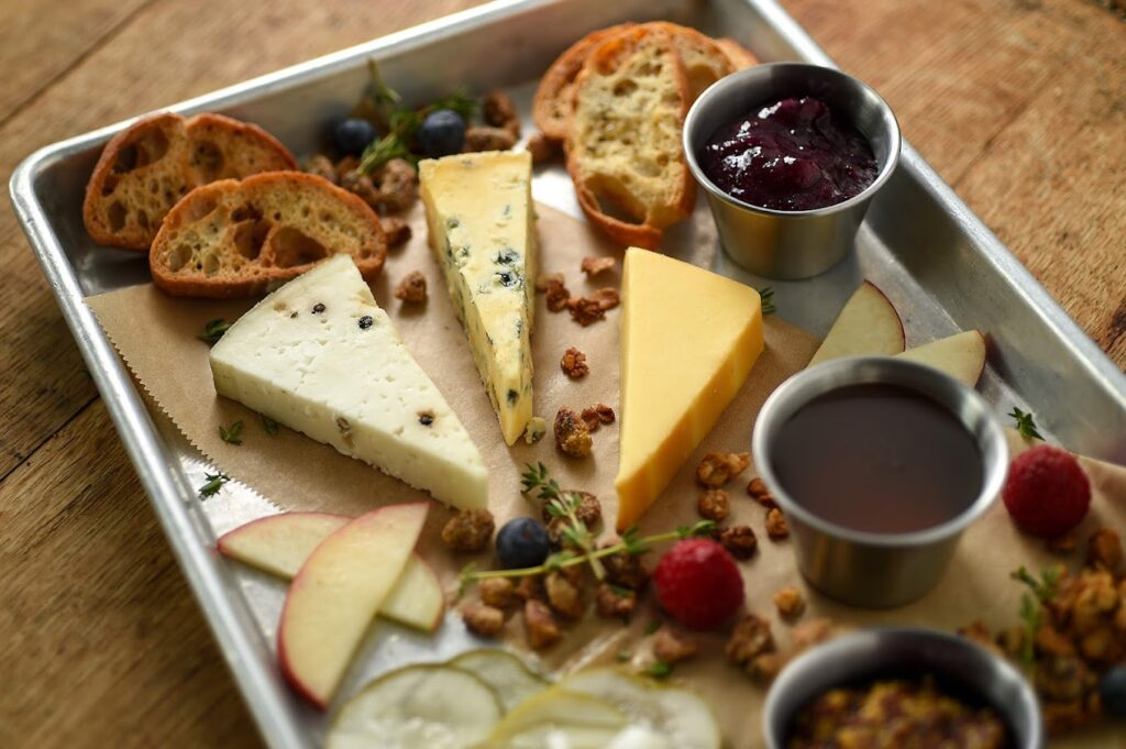 Food photo from the  Tröegs  Brewery. Image shows a cheese board with crusty bread and jam.